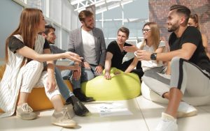 Führungskraft im Gespräch mit Team bei der Besprechung in einem modernen Büro.